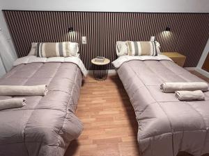 two beds sitting next to each other in a room at Baires&Blo Ático duplex, Terraza chillout exclusiva y vistas al mar in Benicarló