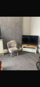 a living room with a chair and a table at Levy Nook 8 in Darlington