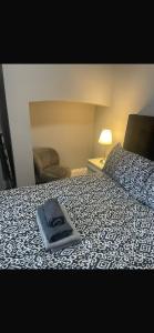 a bed with a blue pillow on top of it at Levy Nook 8 in Darlington