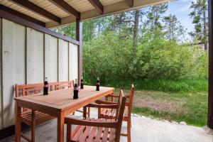 a wooden table with two chairs and two bottles of wine at RMR: Chokeberry 3813 Condo in The Aspens in Wilson +8 photos