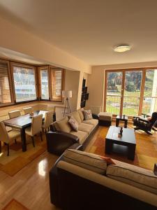 a living room with a couch and a table at Apartman Kadic in Bjelašnica