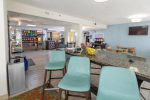 a bar in a waiting room with blue chairs at Hampton Inn Tampa International Airport/Westshore in Tampa