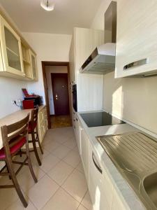 a kitchen with white cabinets and a table and a counter at Villa Ferrari - Park Monza F1 Circuit in Villasanta