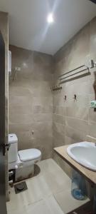 a bathroom with a toilet and a sink at Mirage Bay hotel in Hurghada