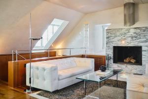 a living room with a white couch and a fireplace at Widder Hotel - Zurichs Luxury Hideaway in Zurich +106 photos