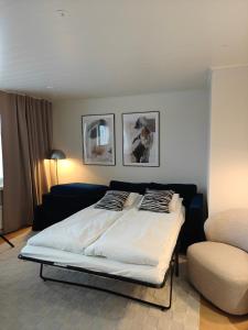 a bedroom with a large bed and a couch at Penthouse Kemi in Kemi