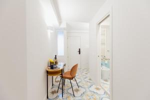 a bathroom with a table and chairs and a toilet at Atri Rooms Centro Storico Napoli in Naples +233 photos