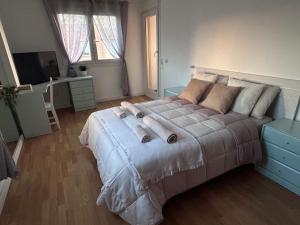 a bedroom with a large bed and a television at Baires&Blo Ático duplex, Terraza chillout exclusiva y vistas al mar in Benicarló