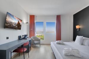 a hotel room with a desk and a bed at Augusta Barcelona Vallès in Granollers +58 photos