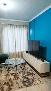 a living room with a couch and a glass table at Lapeng Mogwase Free Parking-Free WIFI in Mogwase