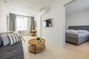 a living room with a couch and a bed at Raise Porta Nuova in Heraklio