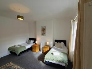 a room with two beds and two lamps in it at Ushaw HillTop View in Ushaw Moor