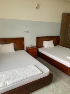 Ένα ή περισσότερα κρεβάτια σε δωμάτιο στο Hoàng Anh Hotel