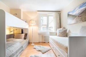 a bedroom with two beds and a window at Alpenheim Apartment in Andermatt