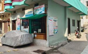 a motorcycle parked in front of a building at Family Room Bed Size 8x6 in Ujjain