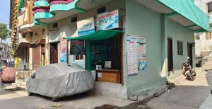 a motorcycle parked in front of a building at Family Room Bed Size 8x6 in Ujjain
