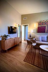 a living room with a couch and a flat screen tv at Puerta de la Ribera Centro in Córdoba