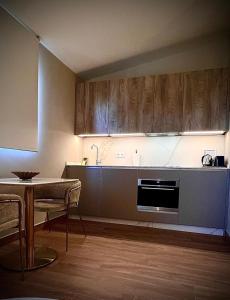 a kitchen with wooden cabinets and a table and a table and a tableablish at Puerta de la Ribera Centro in Córdoba