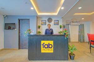 a man standing behind a podium in a room at FabHotel The Vibe - Nr SR Nagar Metro Station in Hyderabad
