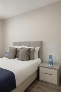 a bedroom with a large white bed and a nightstand at Casa Azul in Ferrel