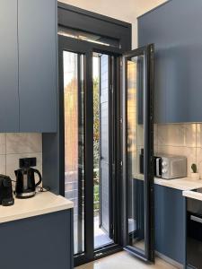 a kitchen with sliding glass doors in a kitchen at Helios 2 in Chios