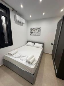 a bedroom with a bed with two towels on it at Helios 2 in Chios