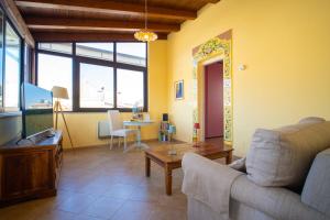 a living room with a couch and a table at Solemar Sicilia - Casa Enza in Santa Flavia