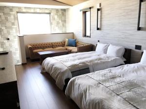 a living room with two beds and a couch at DS2&3 - Vacation STAY 62445v in Tajiri