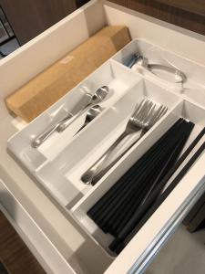 a white tray with silver utensils in a drawer at DS2&3 - Vacation STAY 62445v in Tajiri