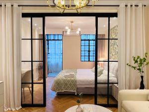 a bedroom with a bed and a large mirror at 梧舍壹号 外滩百年公寓B&B -Riverside Grace Suites on the bund and metro station in Shanghai