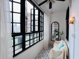 a living room with large windows and a couch at 梧舍壹号 外滩百年公寓B&B -Riverside Grace Suites on the bund and metro station in Shanghai