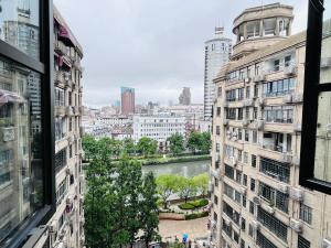 a view of a river between two buildings at 梧舍壹号 外滩百年公寓B&B -Riverside Grace Suites on the bund and metro station in Shanghai