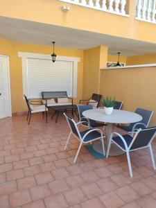 a patio with tables and chairs in a room at La estrella del desierto in Tabernas
