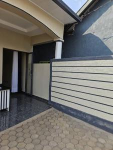 a house with a fence next to a porch at Holliday inn kigali in Kigali