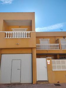 a house with two garage doors and a balcony at La estrella del desierto in Tabernas