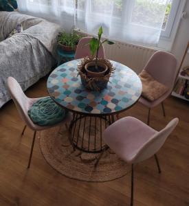 a table with a potted plant on it in a living room at Cosy Coty in Tours +7 photos