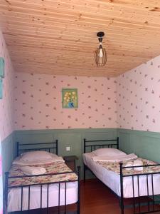 two beds in a room with pink walls at Guesthouse Lantia in Mestia +9 photos