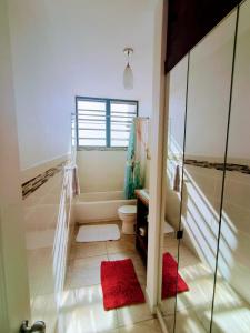 Un baño con bañera, inodoro y ducha. en Sky House, en Rincón