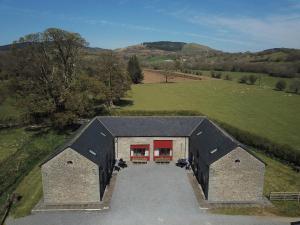 an overhead view of a building with red doors at Hobby Stable Cottage in Cynghordy
