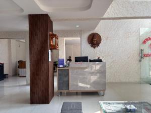an office with a counter and a person in the background at The Mayfair Hotel in Jāmb