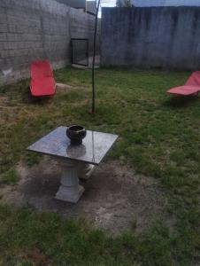 - une table avec un bol au dessus dans une cour dans l'établissement Areco en lo de Mabel, à San Antonio de Areco
