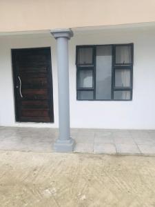 a pole in front of a building with a window at Zalu Lodge in Lusikisiki