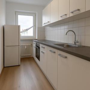 a kitchen with a white refrigerator and a sink at Monteur- und Ferienwohnung Bensheim in Bensheim