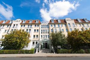 a large white building with stairs in front of it at ACHAT Hotel Dresden Elbufer in Dresden
