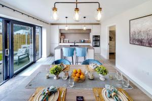 a kitchen and dining room with a table with fruit on it at No 30 at West Point Way Donegal Town in Donegal +17 photos