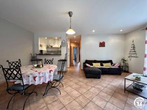 a living room with a table and a couch at Le gite du pech de saint jean in La Redorte
