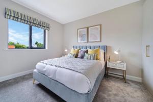 a bedroom with a large bed and a window at No 30 at West Point Way Donegal Town in Donegal