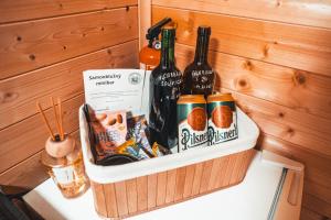 a container filled with bottles of wine and snacks at Útulná maringotka uprostřed přírody pro dokonalý odpočinek ve dvou in Borovy