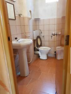 a bathroom with a toilet and a sink at Sky View Kandy in Kandy