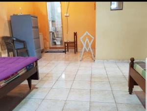 a living room with a tile floor and a refrigerator at Sky View Kandy in Kandy
